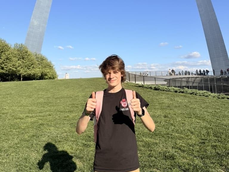Henry in a 3142C robotics shirt beneath the Gateway Arch in St. Louis.